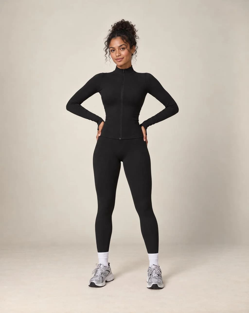Black zip-up workout jacket and matching leggings set, long sleeves and slim fit