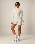 White fitted zip-up yoga jacket with stand collar, long sleeves
