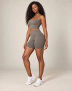 High-waist fitted yoga shorts, gray, smooth stretchy fabric with mid-thigh length.