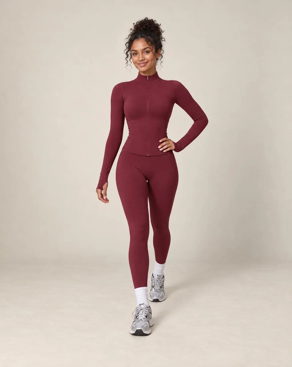 Burgundy zip-up workout jacket and matching leggings set with long sleeves and slim fit