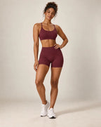 Plum purple cross-back sports bra and matching workout shorts set