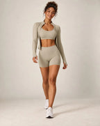 Sage sports bra and biker shorts workout set with long-sleeve layer