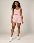 High-waist fitted yoga shorts, retro pink, smooth stretchy fabric with mid-thigh length.