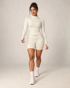 White stand-collar zip-up yoga jacket with long sleeves and front zipper