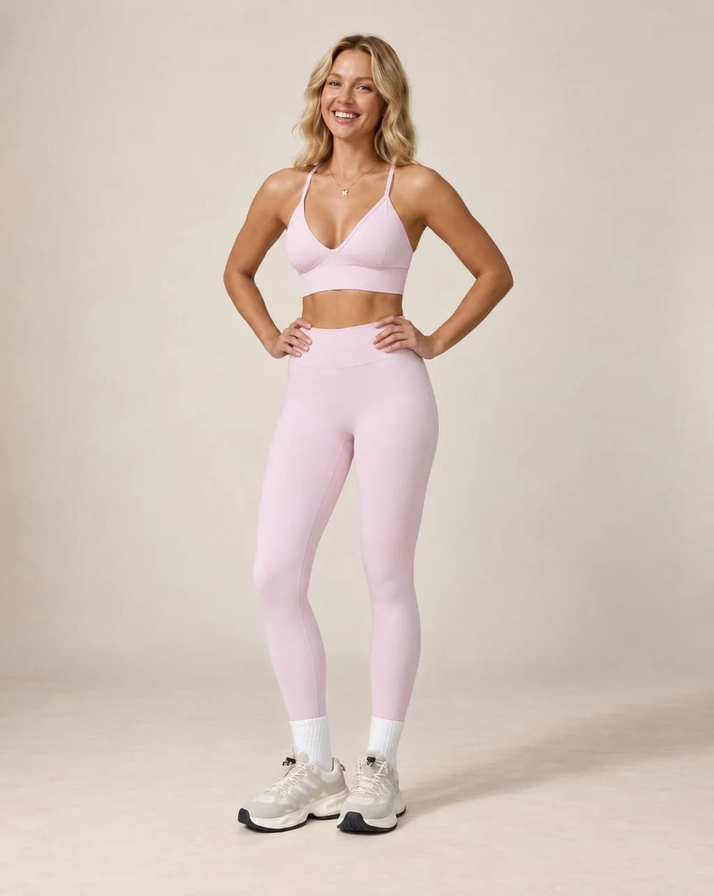 Light pink high-waist fitted workout leggings with ankle-length leg cuffs