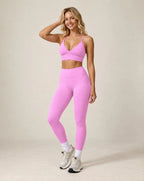 Pink high-waist fitted workout leggings with ankle-length leg cuffs
