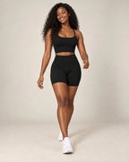 High-waist fitted yoga shorts, black, smooth stretchy fabric with mid-thigh length.