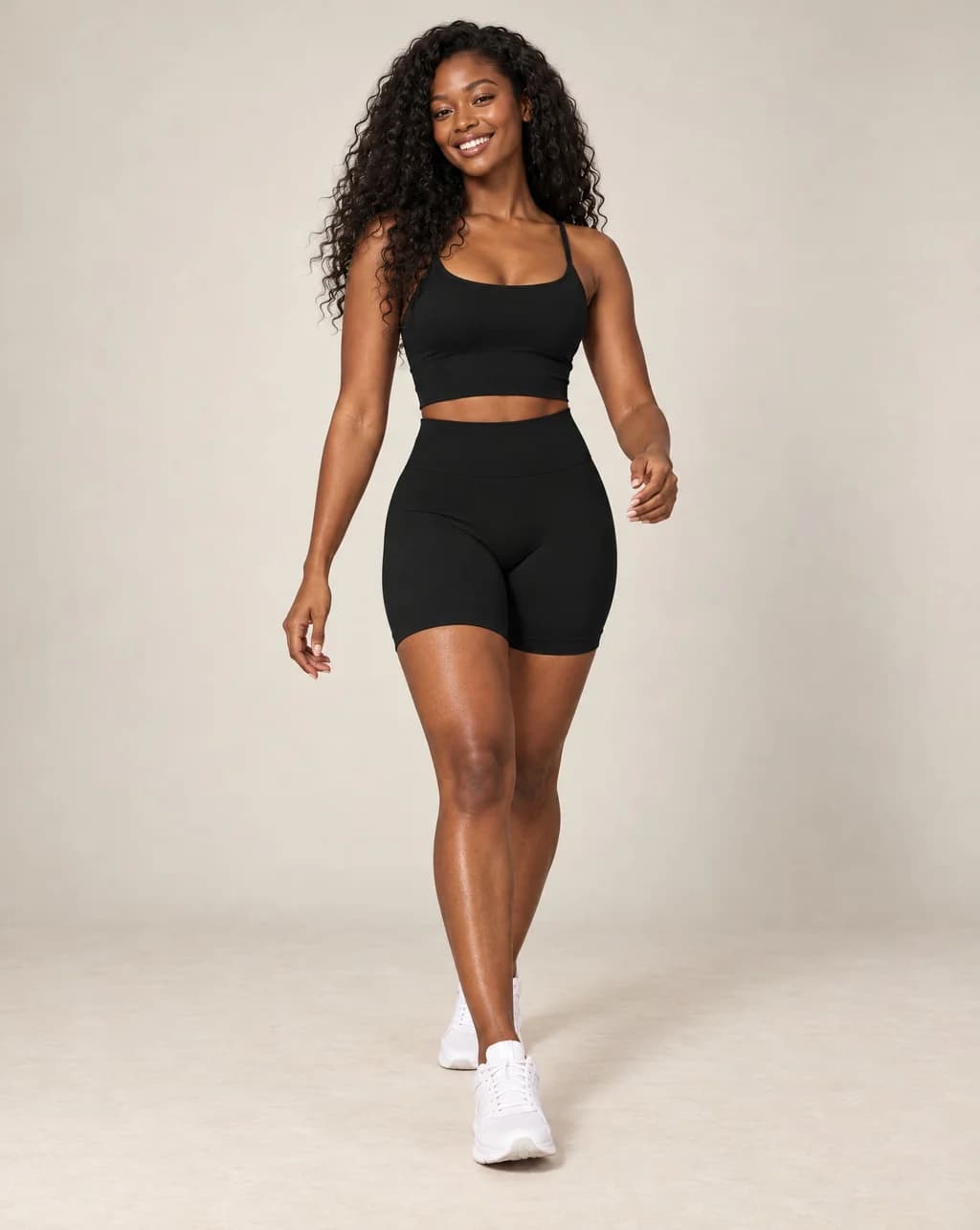 High-waist fitted yoga shorts, black, smooth stretchy fabric with mid-thigh length.