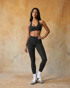 Dark black halter sports bra and high-waist leggings set, fitted stretch full length