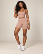 High-waist fitted yoga shorts, coffee beige, smooth stretchy fabric with mid-thigh length.