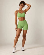 Green cross-back sports bra and matching workout shorts set