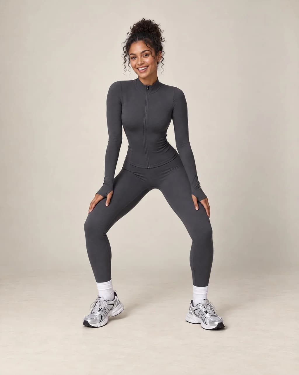 Dark gray zip-up workout jacket and matching leggings set, long sleeves and slim fit