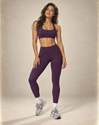 Purple sports bra and high-waist leggings set with fitted, smooth finish.