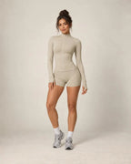 Zip-up yoga jacket and fitted shorts set, light beige with long sleeves and zip front