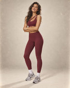 Dark red sports bra and high-waist leggings set with wide, supportive waistband.