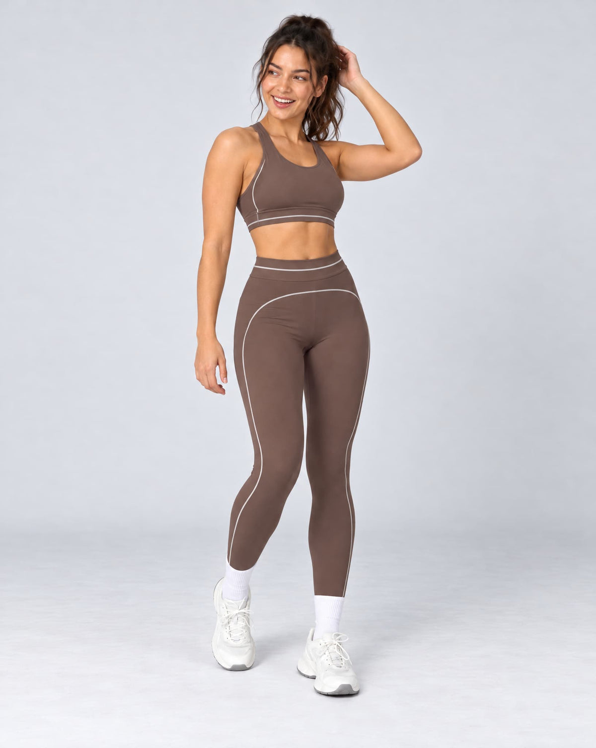 High-waisted foldover yoga pants in dark brown with contrast colorblock side piping.