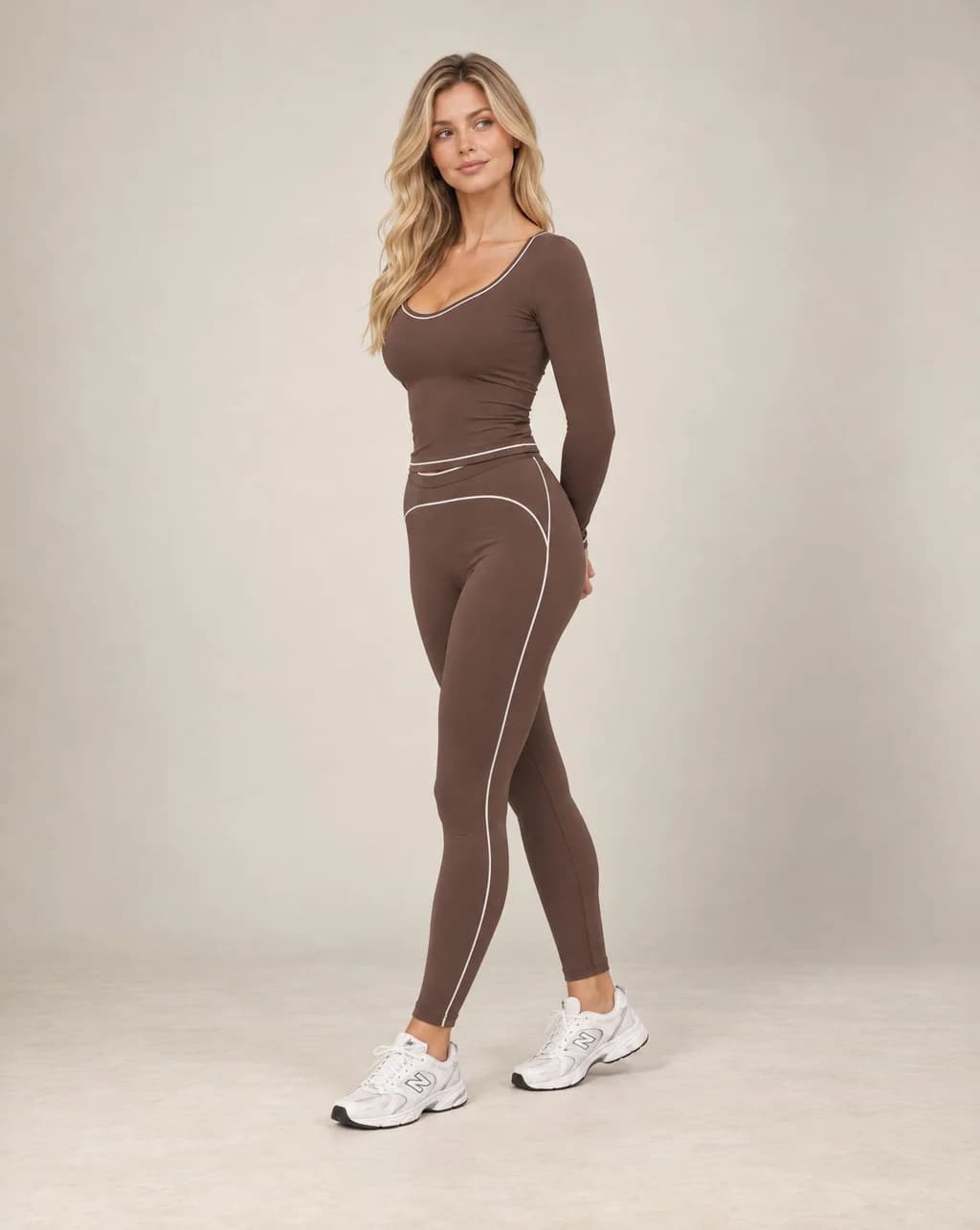 Brown long-sleeve slim-fit yoga top with contrast seam lines along the neckline and sides