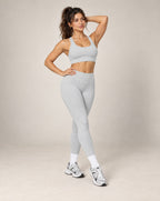 Light gray high-waisted slim-fit yoga pants with brushed quick-dry fabric, full length