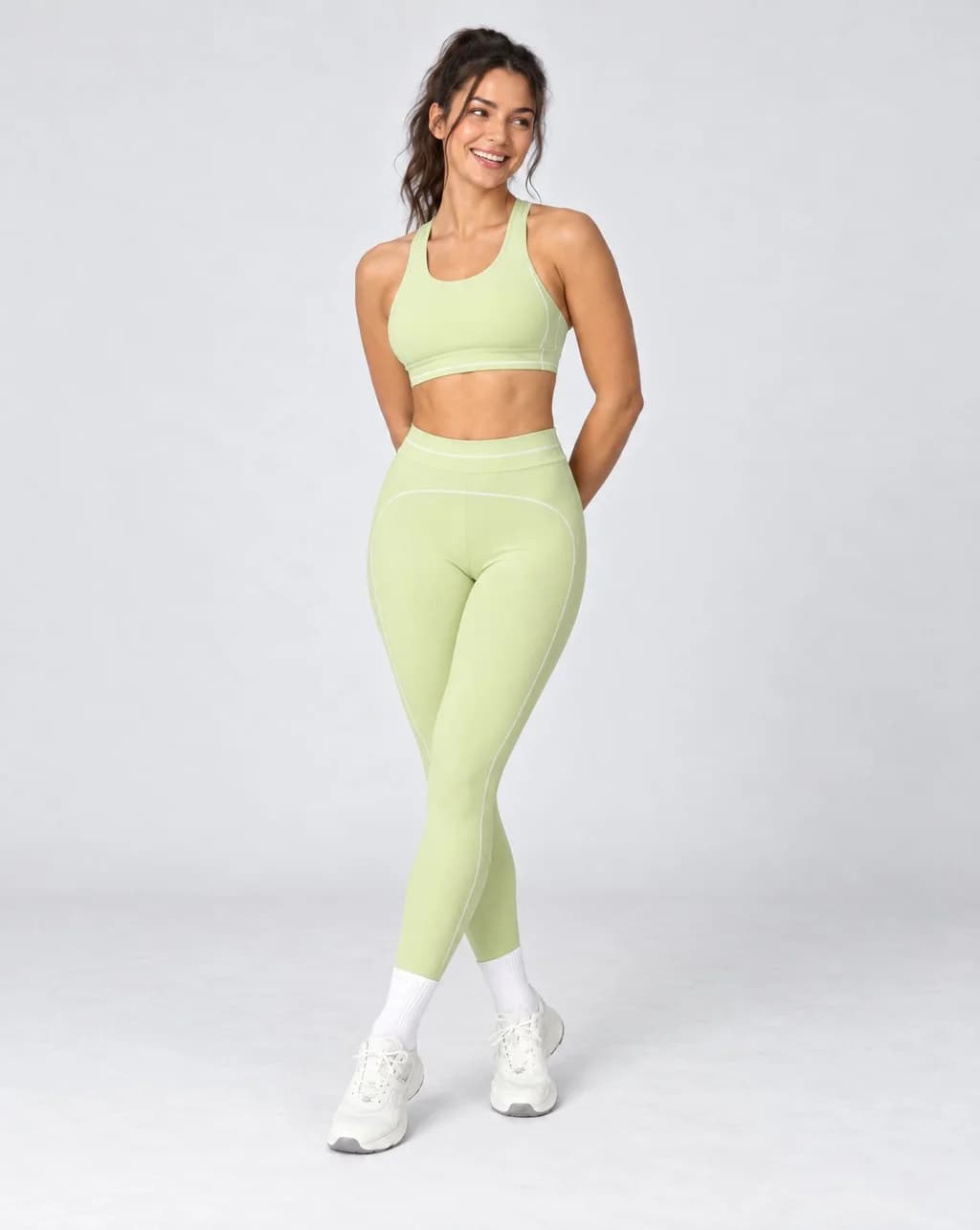 High-waisted foldover yoga pants, light lime green with contrast colorblock side lines.
