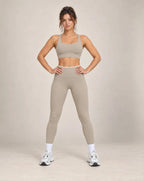 Taupe high-waisted yoga pants with white waistband and ankle-length legs