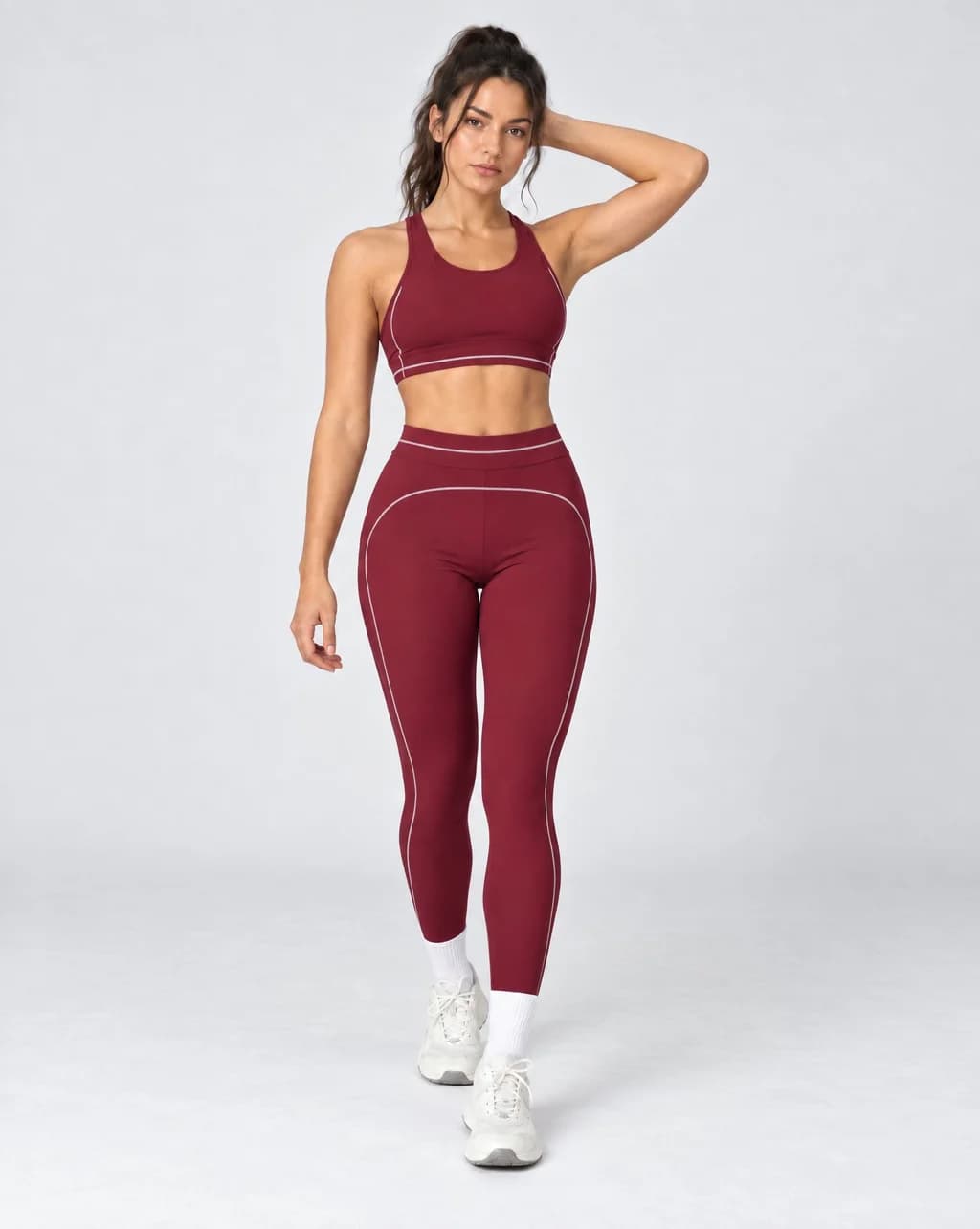 High-waisted foldover yoga pants in burgundy with contrast colorblock side piping.