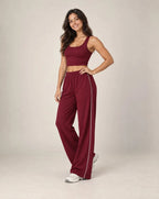 Cherry red high-waisted relaxed straight-leg sweatpants with elastic waistband and side stripe