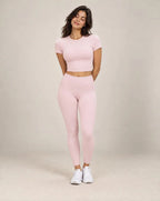 Women's fitted short-sleeve running shirt, light pink crew neck.