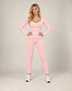 Pink long-sleeve slim-fit yoga top with contrast seam detailing at sides and hem