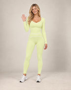 Lime green long-sleeve slim-fit yoga top with contrast piping and side seam detailing
