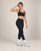 Black high-waisted yoga pants with white side panels and ankle-length legs