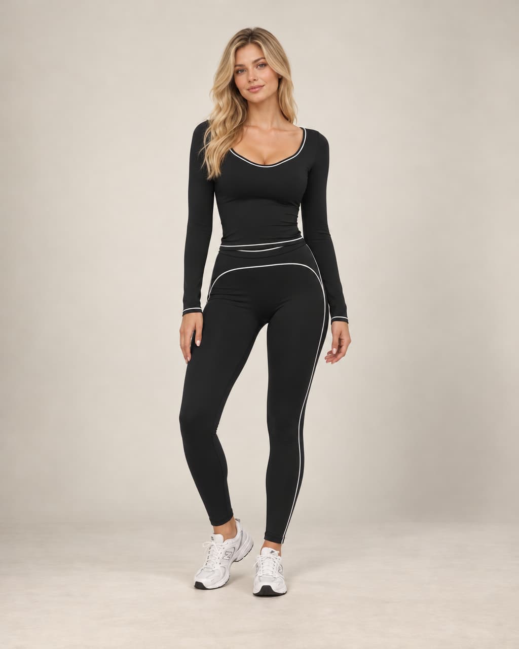 Black long-sleeve slim-fit yoga top with contrast piping around the scoop neckline