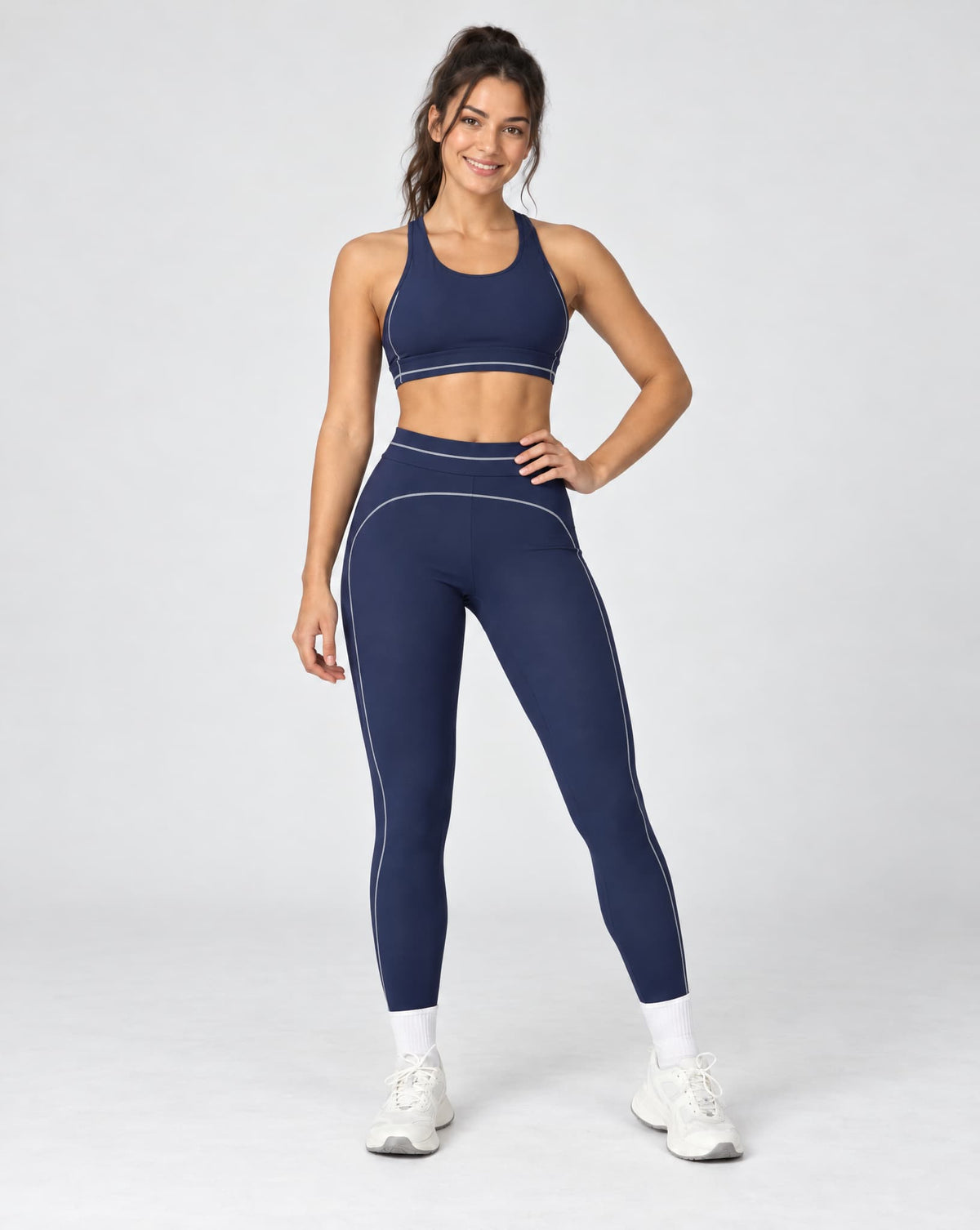 High-waisted foldover yoga pants in navy blue with contrast colorblock side piping.