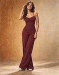 Burgundy thin-strap wide-leg yoga jumpsuit with scoop neckline and flared pants